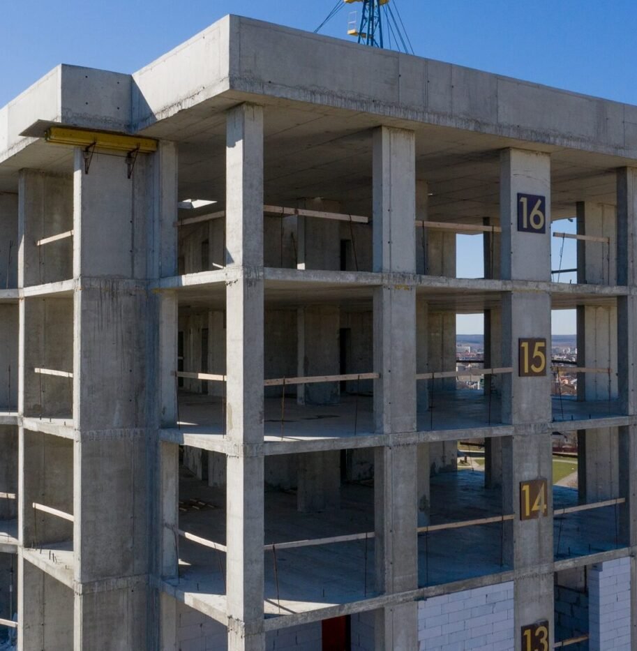 Aerial view of concrete frame of tall apartment building under construction in a city Aerial view of concrete frame of tall apartment building under construction in a city.