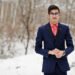 Stylish indian student man in suit and glasses posed at winter day outdoor.