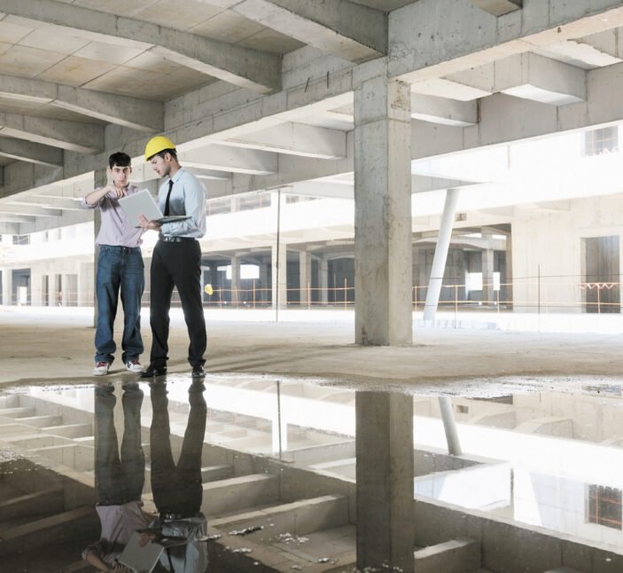 Team of business people in group, architect and engeneer  on construciton site check documents and business workflow on new building